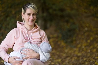 Portrait of a smiling young woman holding outdoors