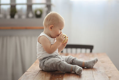 Portrait of cute boy sitting on table