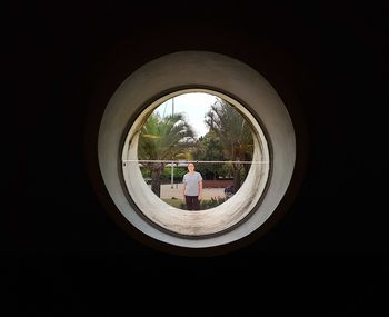 Man seen through archway