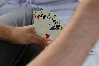 Midsection of person playing with text on table