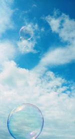 Low angle view of bubbles against sky