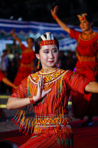 Woman wearing costume dancing at night