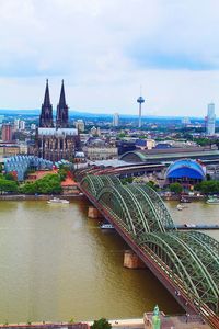 Bridge over river against buildings in city