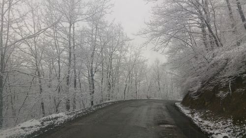 Road passing through snow covered landscape