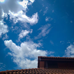 Low angle view of building against cloudy sky