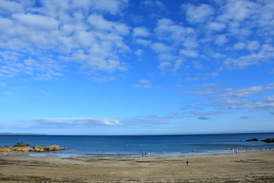 Scenic view of beach against blue sky
