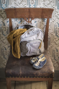 Bag and kids shoes on chair