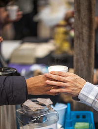 Cropped image of people holding glass