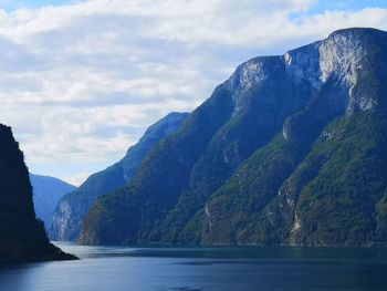 Scenic view of sea and mountains against sky