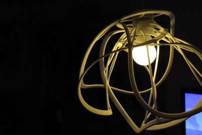 Close-up of illuminated lamp against black background