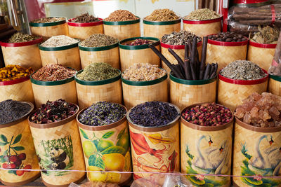 Colorful containers of dried spices, tea and incense at bazaar market in dubai