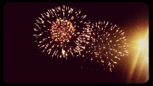 Low angle view of firework display at night