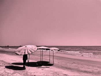 People on beach against sky