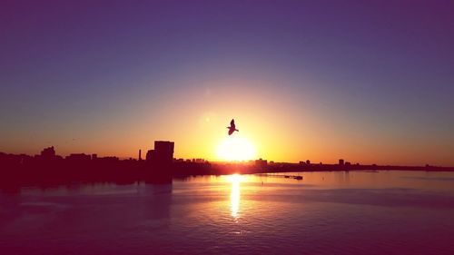 Scenic view of silhouette city against sky during sunset