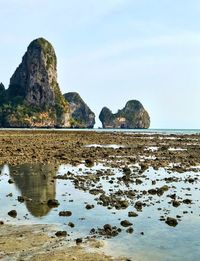 Scenic view of rocks in sea against sky