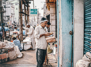 People working on street in city