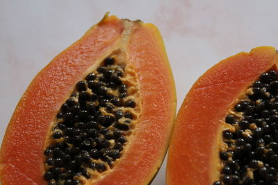 Close-up of orange fruit against white background