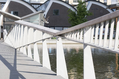 Bridge over river against buildings