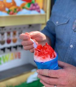 Midsection of man holding ice cream