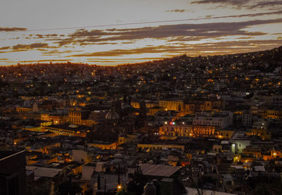 High angle shot of illuminated cityscape against sky