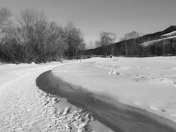 Scenic view of snow covered field against sky