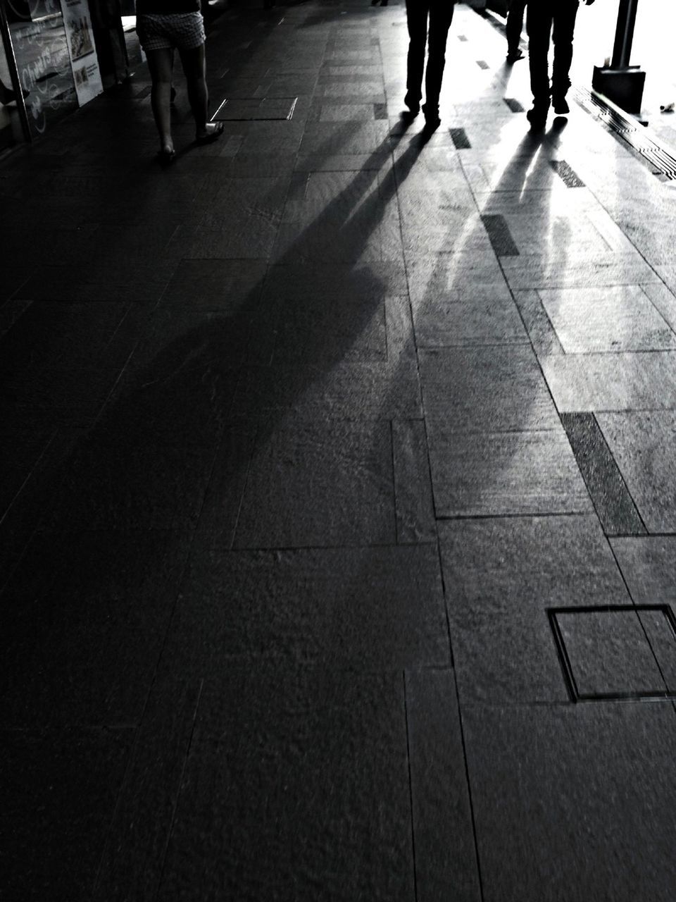 walking, men, low section, person, lifestyles, tiled floor, indoors, the way forward, city life, shadow, transportation, street, medium group of people, unrecognizable person, flooring, leisure activity, high angle view