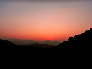 Scenic view of silhouette mountains against sky during sunset