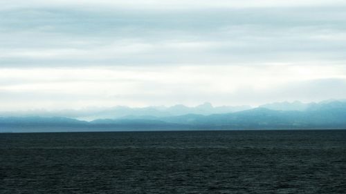 Scenic view of sea against cloudy sky