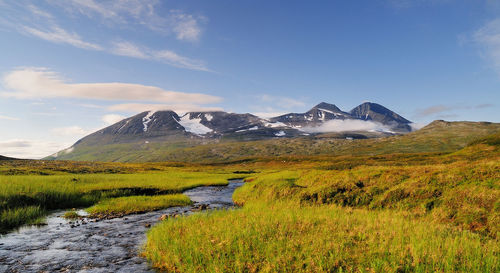 Scenic view of lake and mountains against sky