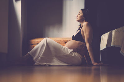 Pregnant woman sitting at home