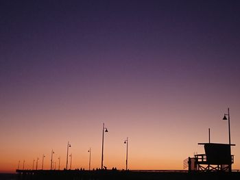 Low angle view of silhouette street against sky during sunset