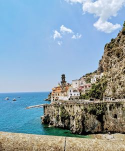 Building by sea against sky