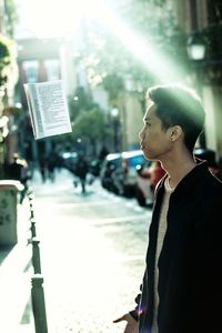 Man standing on street in city