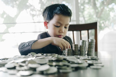 Portrait of boy in front of wooden table