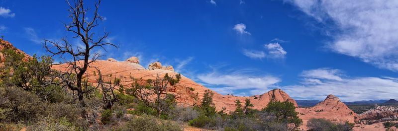 Panoramic view of rocky mountains against blue sky