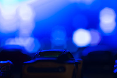 Defocused image of people at night