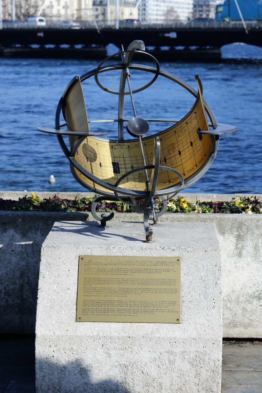 CLOSE-UP OF TEXT ON METAL BY SEA AGAINST SKY