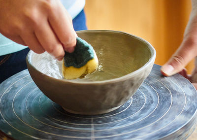 Close-up of hand at craft of pottery