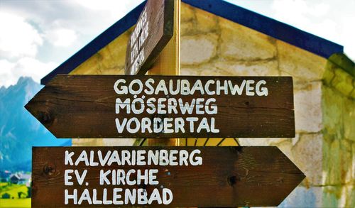 Close-up of signboard against the sky