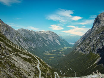 Scenic view of valley and mountains against sky