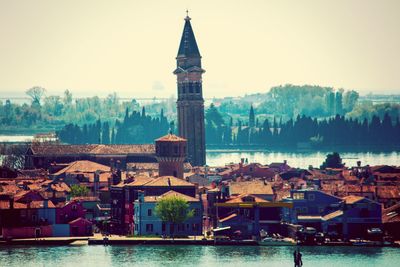 Buildings in city against clear sky