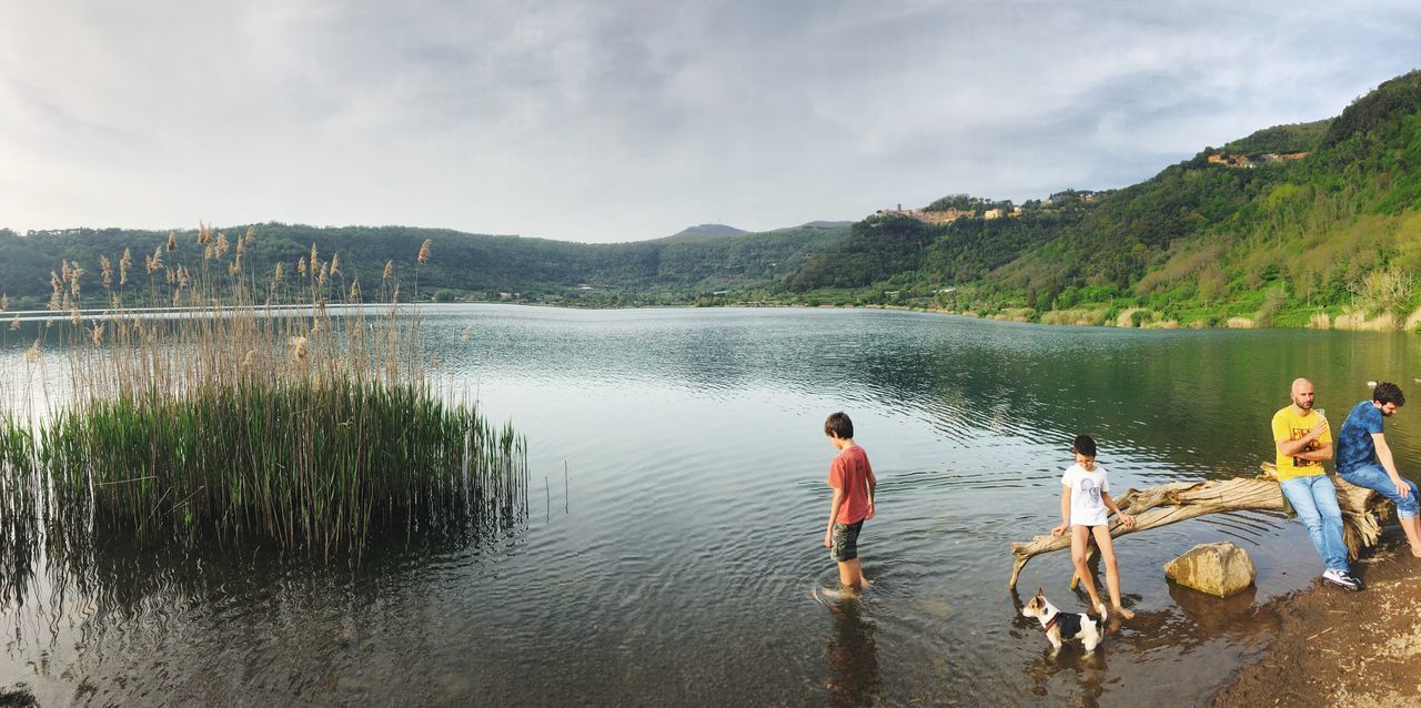 water, lake, men, real people, beauty in nature, mountain, scenics - nature, sky, lifestyles, nature, day, group of people, cloud - sky, leisure activity, plant, tranquility, non-urban scene, people, togetherness, outdoors