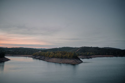 Scenic view of lake against sky during sunset