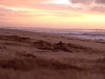 Scenic view of beach against sky during sunset