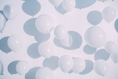 Full frame shot of balloons against white background