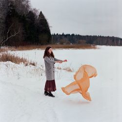 Woman standing on snow covered land