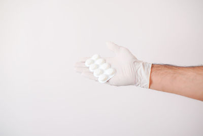 Close-up of hand holding white background