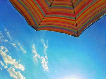 Low angle view of umbrella against blue sky