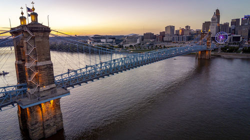 Bridge over sea against buildings in city