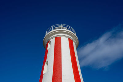 Low angle view of lighthouse against blue sky